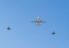 Mid-Flight Axe Attack Stuns Investigators A commercial airplane flying above two military jets in a clear blue sky