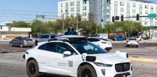 A Waymo autonomous vehicle driving in an urban area