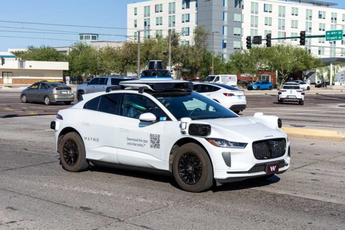 A Waymo autonomous vehicle driving in an urban area