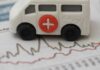 Toy ambulance on financial chart