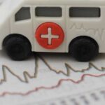 Toy ambulance on financial chart