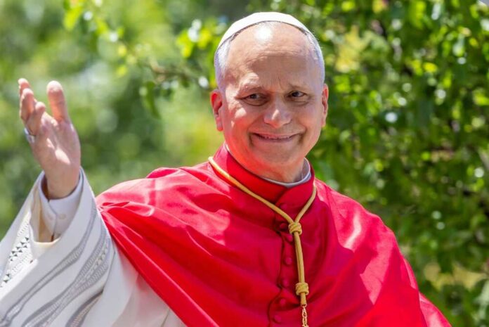 Catholic cardinal smiling and waving outdoors