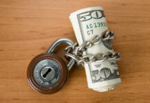 Regulation Rollback: Billions at Stake Rolled US dollars wrapped in chain with a padlock