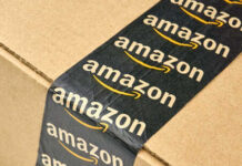 Urgent Amazon Baby Seat Recall Close-up of an Amazon-branded shipping box tape on a cardboard box